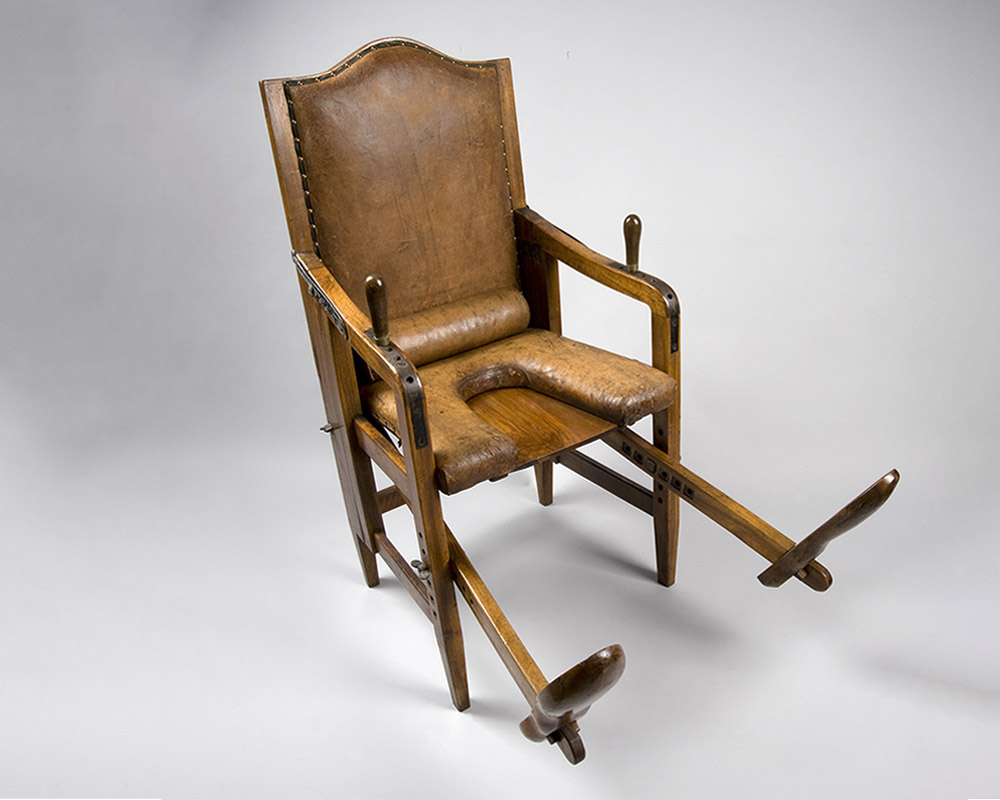 adjustable parturition chair, or birthing chair, German, 17th century. Full 3/4 view, grey background.