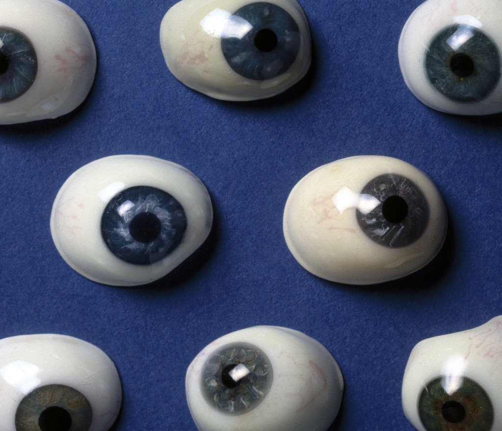 Collection of glass artificial eyes, French, 19th century Collection of glass artificial eyes, French, 19th century on a blue background